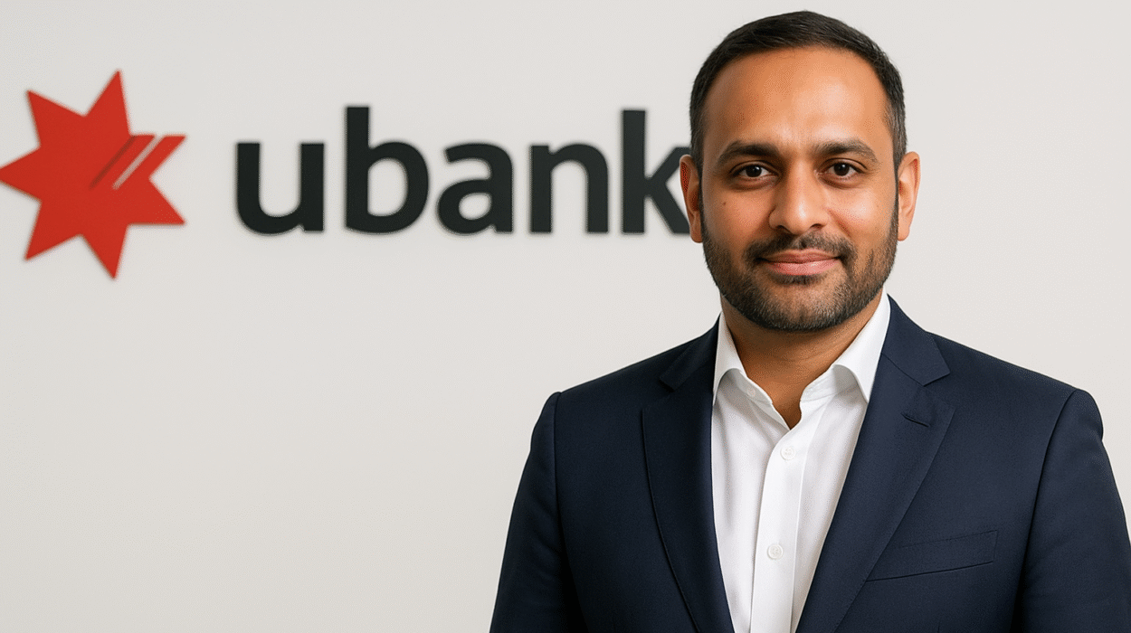 Kanishka Raja, newly appointed CEO of Ubank under National Australia Bank, standing confidently in front of the Ubank logo.